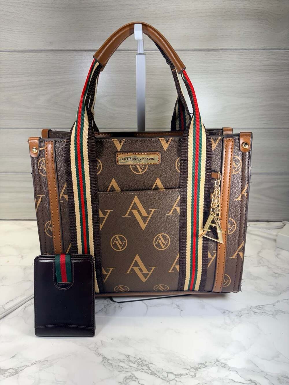 Adrienne Vittadini brown satchel handbag featuring an "AV" logo
